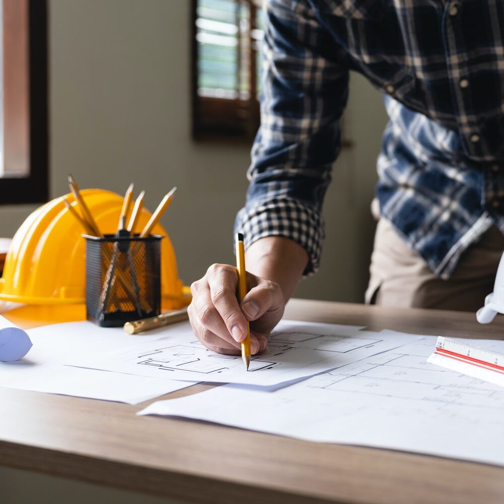 Engineer architect designer freelance work on start-up project drawing, construction plan